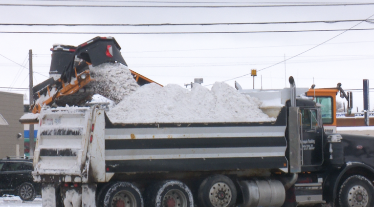 Road crews work to clear snow from city streets. 