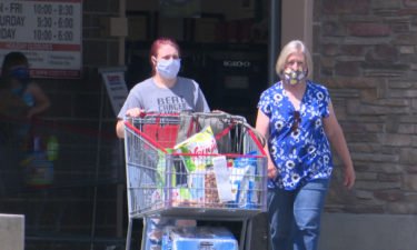 two women wearing masks as they leave costco