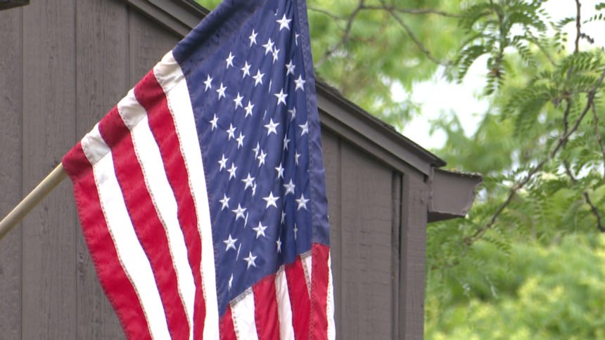 U.S. flag hangs from a front porch