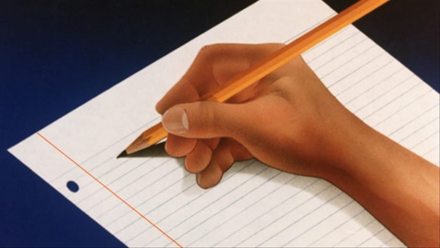 hand w: pencil writing on sheet of notebook logo MGN Online-writing logo_write logo_school logo