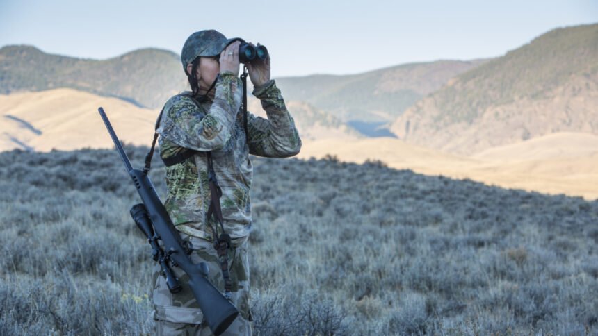 Female hunter looking in binoculars for her animal Lope hunt October 2015_ IDFG