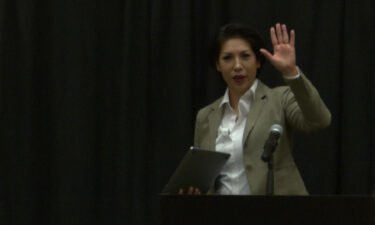 jordan waving to camera from behind podium