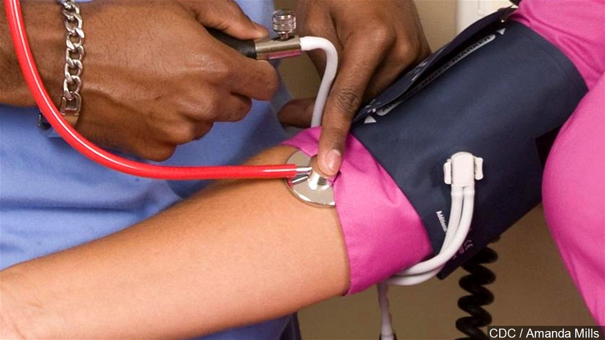 A nurse taking a woman's blood pressure.