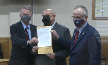 Governor Brad Little with Christopher Tapp and Senator Doug Ricks after he signed a bill to compensate wrongly convicted.