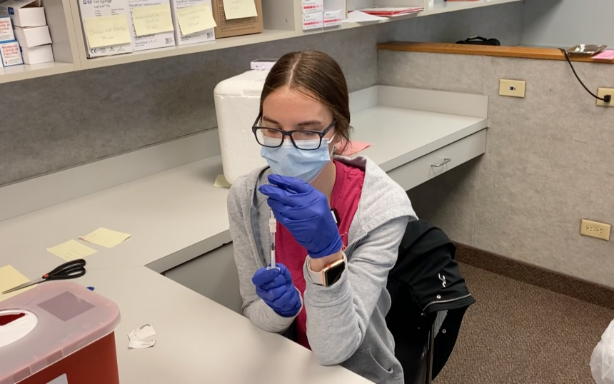 Piercly Murmester prepares vaccines at Sports & Orthopedic Clinic at ISU