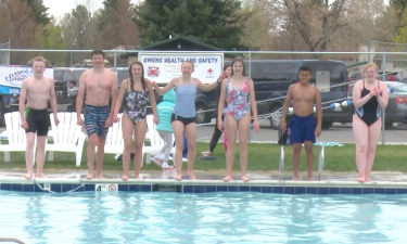 Kids jumping into Ammon Swimming Pool