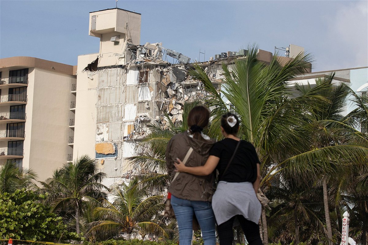 Maria Fernanda Martinez and Mariana Cordeiro look on as search and rescue operations continue at the site of the partially collapsed 12-story condo building on Friday in Surfsid
