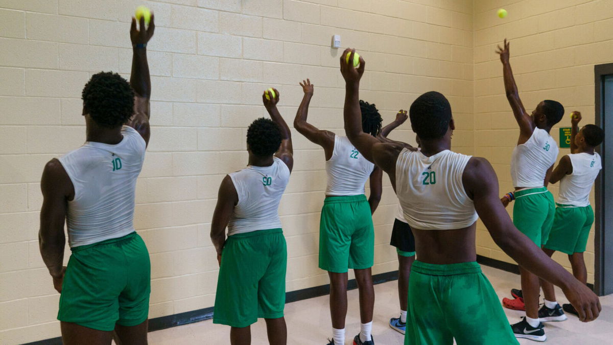 <i>Elijah Nouvelage for CNN</i><br/>Members of a varsity football team practice at school. Community leaders say activities