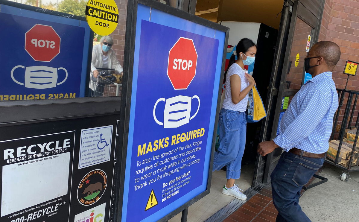 <i>Chris Delmas/AFP/Getty Images</i><br/>People shop at a grocery store enforcing the wearing of masks in Los Angeles on July 23. Top federal health officials have debated whether to issue new guidance on masks and are close to announcing their decision as the Delta variant fuels new outbreaks in the United States.