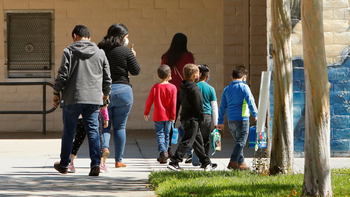 <i>Carolyn Cole/Los Angeles Times/Getty Images</i><br/>Students wearing masks head to lunch break during summer school at Hooper Avenue Elementary School in Los Angeles on June 23.