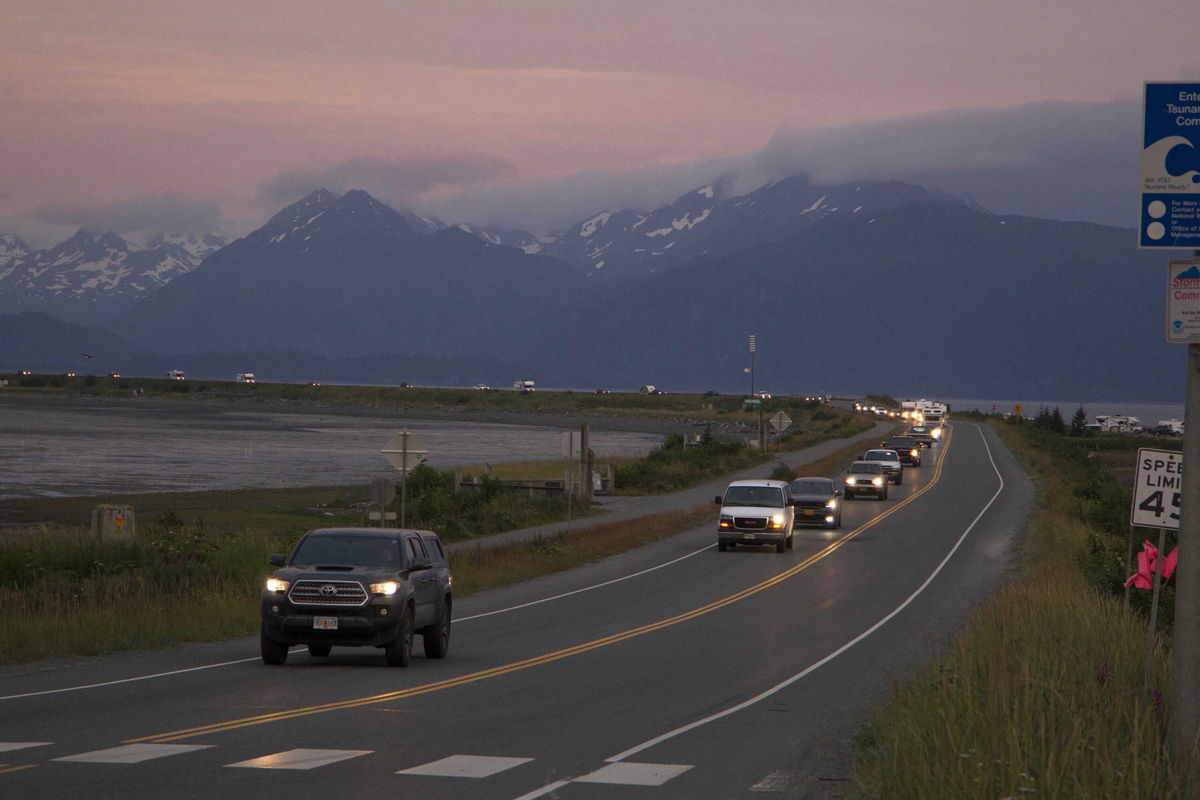 <i>Sarah Knapp/AP</i><br/>A line of cars evacuates the Homer Spit in Homer