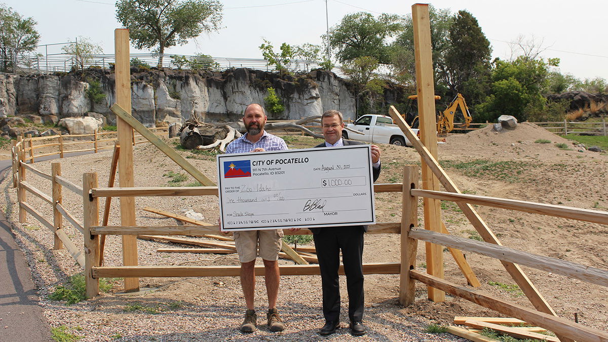 Pocatello Mayor Brian Blad, right, presents Peter Pruett, Zoo Idaho Superintendent, with a $1,000 check at one of the rest spots under construction at Zoo Idaho. 