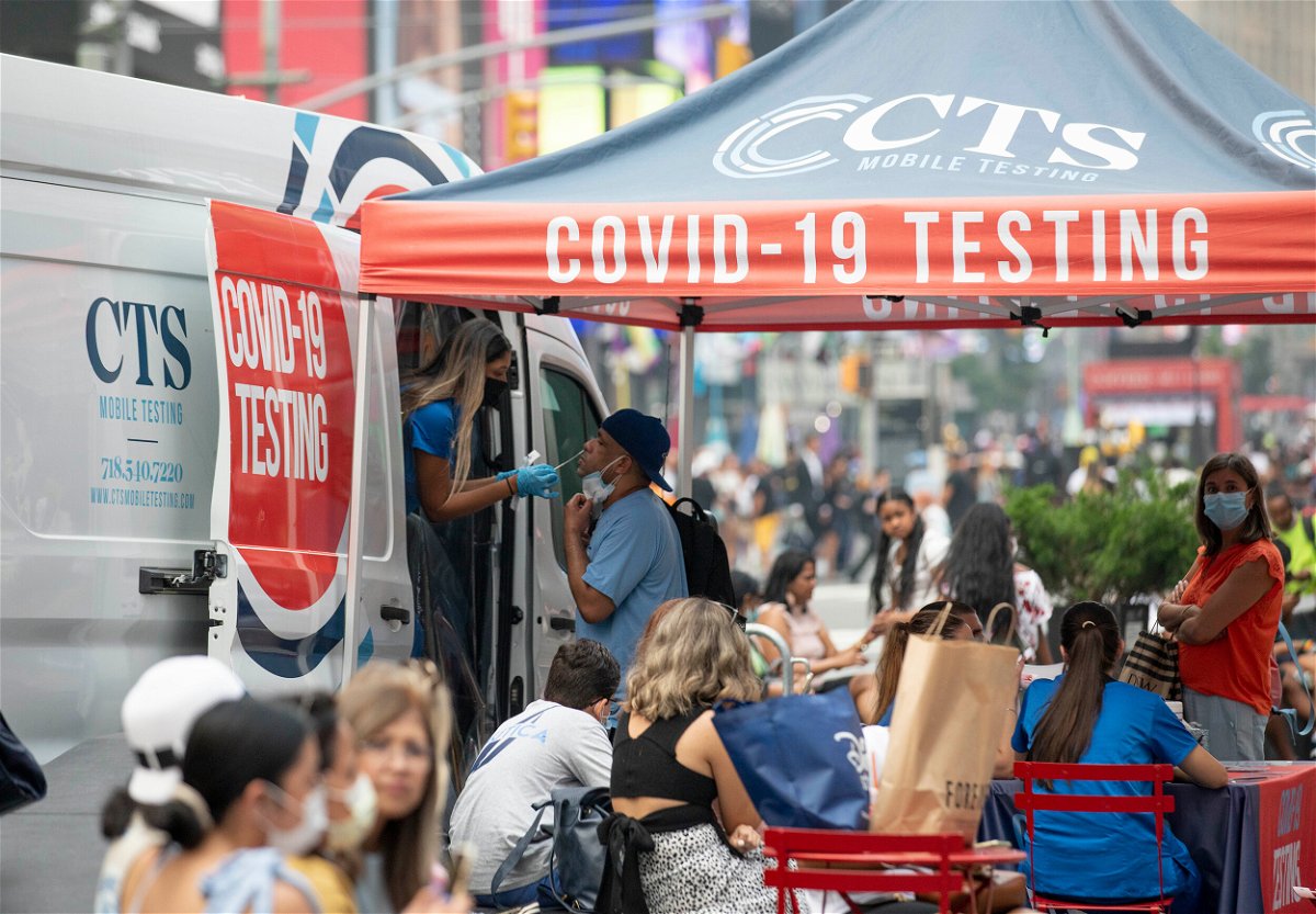 <i>Wang Ying/Xinhua/Sipa USA/FILE</i><br/>A man receives a Covid-19 test at a mobile testing site in Times Square