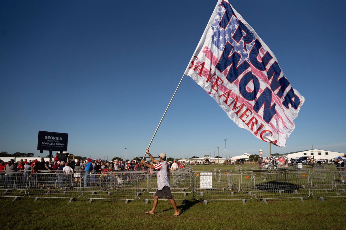 <i>Sean Rayford/Getty Images</i><br/>A man carries a flag that reads