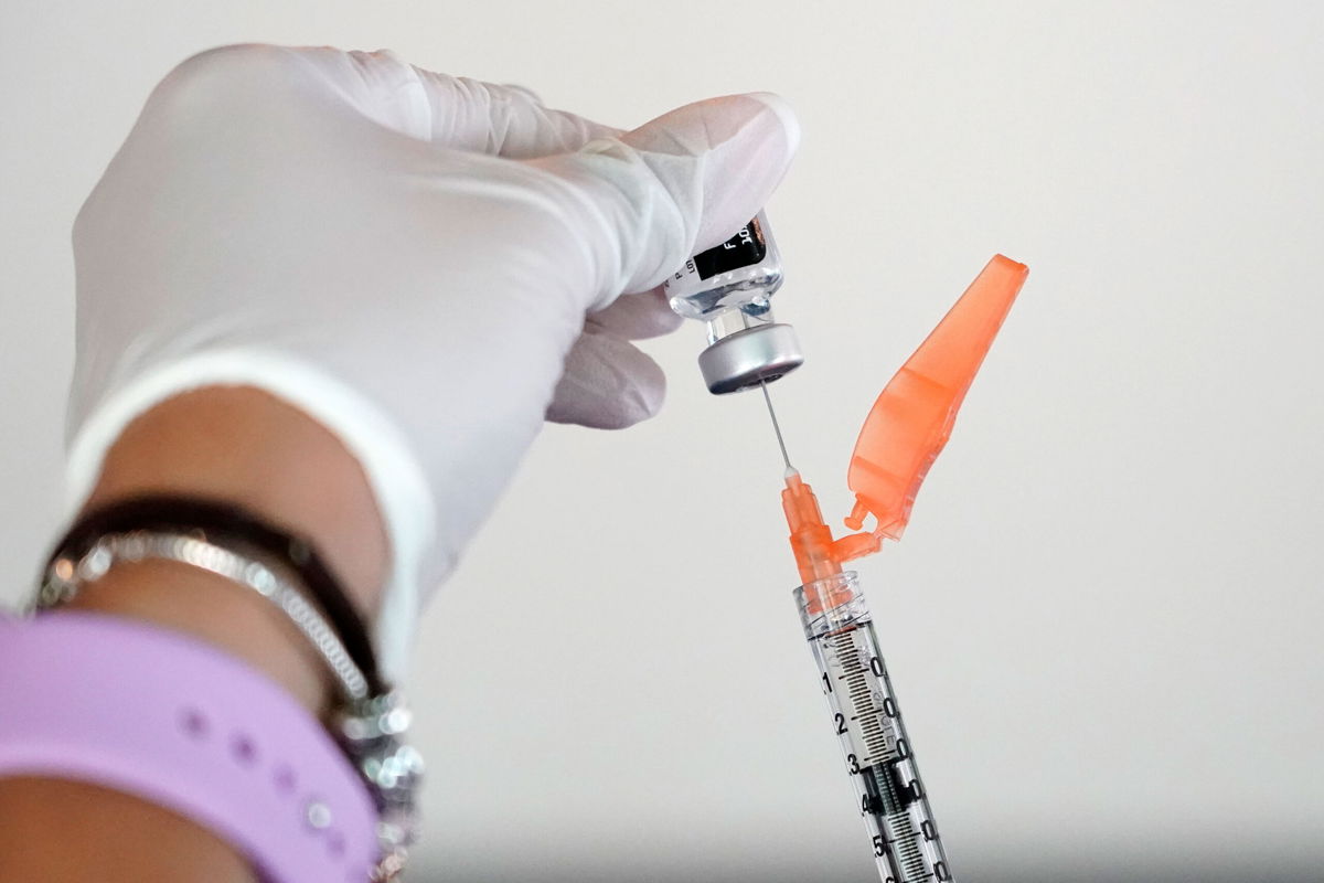 Tameiki Lee, a nurse with the Jackson-Hinds Comprehensive Health Center, loads a syringe with the Pfizer/BioNTech vaccine at a facility near Jackson State University in Mississippi on Tuesday.