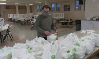 Volunteer packaging meals at Holy Spirit Catholic School