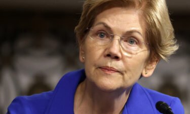 Democratic Senator Elizabeth Warren wants federal regulators to investigate whether any laws were broken by the shell company that is facilitating former President Donald Trump's return to Wall Street. Warren is shown here on September 28