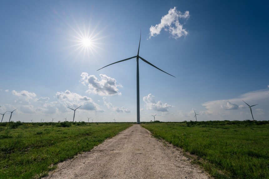 The increased focus by big businesses and governments on cleaner environmental policies could be inflationary in the short-term. Wind turbines are shown on June 15