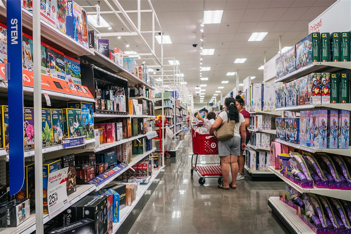 <i>Brandon Bell/Getty Images</i><br/>A family shops for toys at a Target store on October 25
