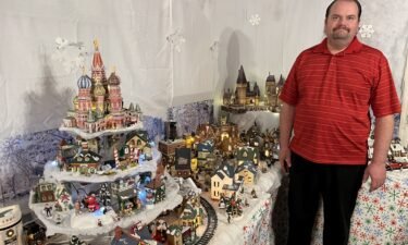 Jessie Halford poses with his Christmas village display