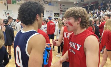 Pocatello's Julian Bowie celebrates with students after 64-60 win