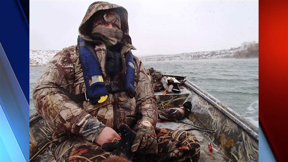Duck hunter in boat in cold conditions