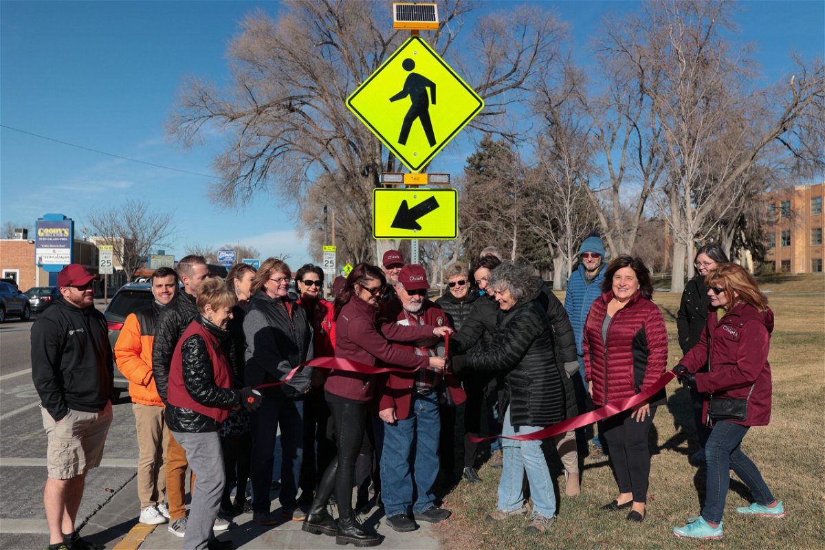 Members of Idaho State University, the Rotary and McDonald's cut a ribbon for new crosswalk signs along 5th Ave. on Tuesday, December 21, 2021.