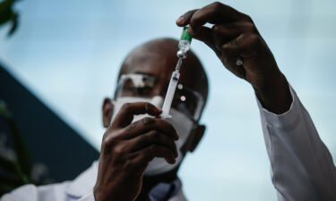 A healthcare worker prepares a dose of the AstraZeneca/Oxford vaccine before administering it to doctors at the Osvaldo Cruz Foundation (FIOCRUZ) on January 23