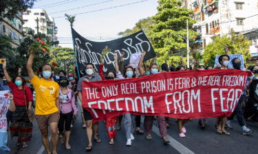 Protesters walk down the street to protest against the military coup and demand the release of deposed civilian leader Aung San Suu Kyi.