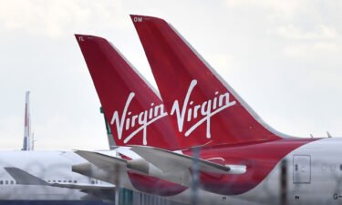 Tailfins of parked Virgin Atlantic passenger aircraft are pictured on the apron at Heathrow Airport