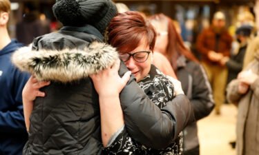 People hug during a vigil following a shooting at Oxford High School at Lake Pointe Community Church in Lake Orion