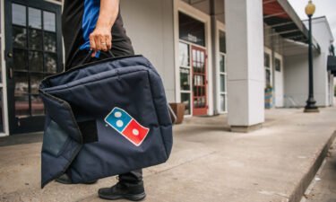 A Domino's Pizza employee returns from a delivery on July 22