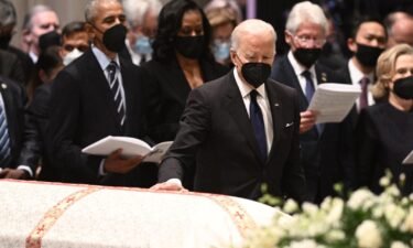 President Joe Biden pays his respects at the casket of former Secretary of State Madeleine Albright during a funeral service at the Washington National Cathedral in Washington