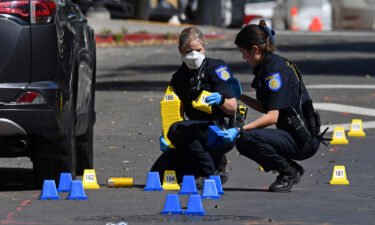 Sacramento Police crime scene investigators place evidence markers on 10th street at the scene of a mass shooting in Sacramento