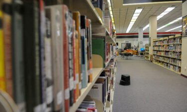 Books line the shelves of a high school library in Brownsville