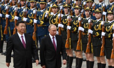 Chinese President Xi Jinping and Russian leader Vladimir Putin review a military honor guard outside the Great Hall of the People in Beijing on June 8