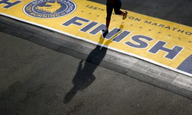 A runner casts a shadow as she crosses the finish line of the 125th Boston Marathon in Boston in October. This year