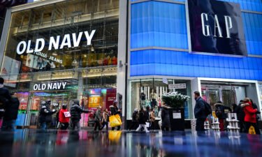 Pedestrians walk past Old Navy and GAP stores in Times Square