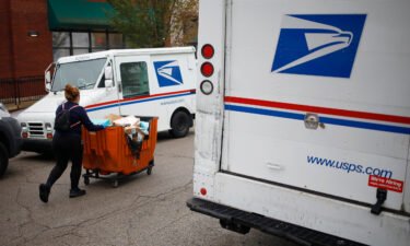 A worker pushes a mail cart outside a US Postal Service distribution center in Chicago.
