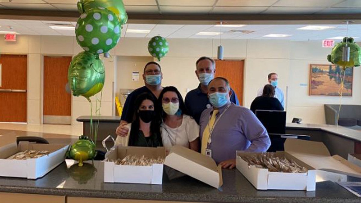 Team members passing out cookies to team members in celebration of hospital week and our Leapfrog A rating.