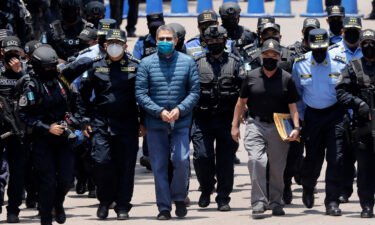 Hernández is escorted by members of the police special forces in Tegucigalpa ahead of his extradition.
