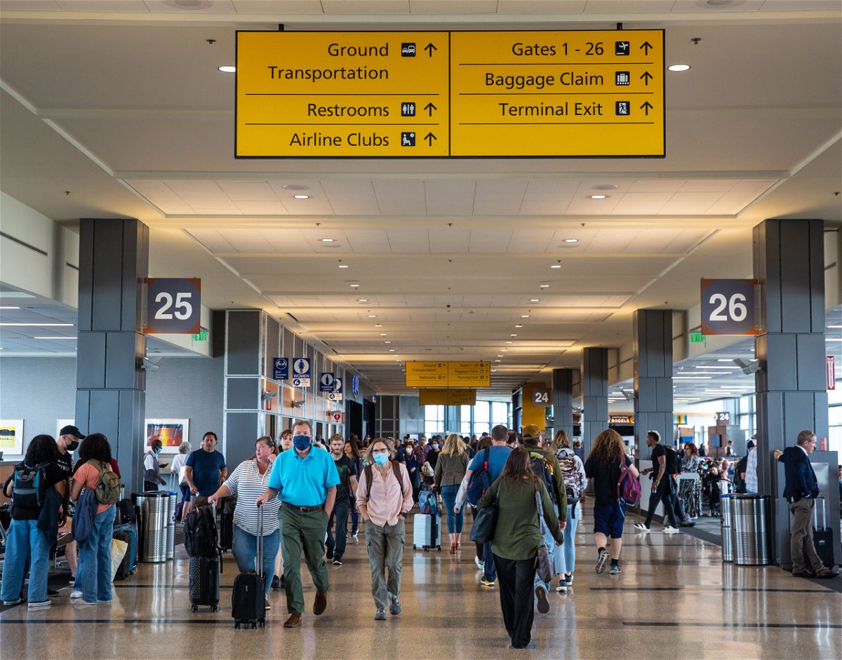 <i>George Rose/Getty Images</i><br/>Travelers walk through the west terminal to catch their flights on May 23 in Austin