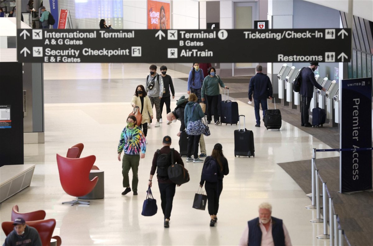 <i>Justin Sullivan/Getty Images</i><br/>Airline passengers walk through San Francisco International Airport on April 19. Travel industry officials pressed the Biden administration on May 31 to end pre-travel testing.