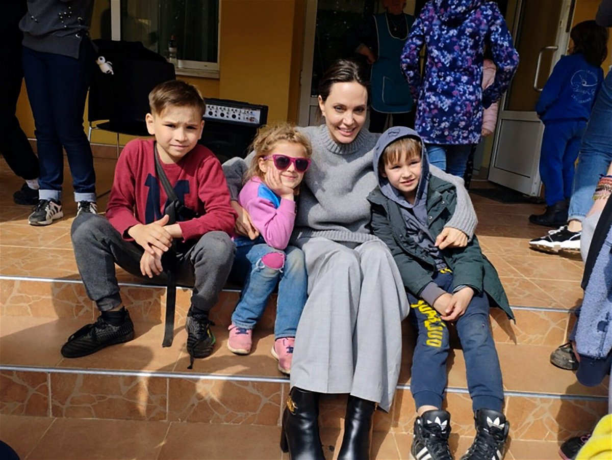 <i>Maksym Kozutsky/AP</i><br/>Angelina Jolie poses for photo with children in Lviv