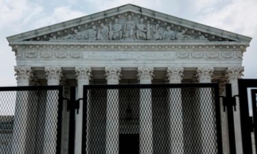 The U.S. Supreme Court Building is seen behind a temporary security fencing on May 20 in Washington