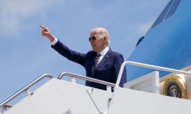 President Joe Biden gestures as he boards Air Force One for a trip to South Korea and Japan on May 19