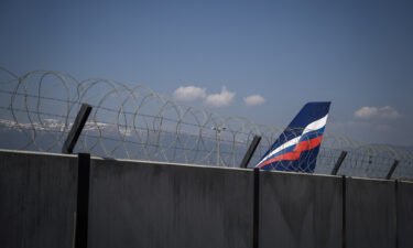 The tail of an Airbus A321-211 aircraft of Russian airline Aeroflot with registration VP-BOE is seen over the wall of the long term parking for planes of Geneva Airport on March 25. Due to sanctions imposed on Russia over the country's invasion of Ukraine