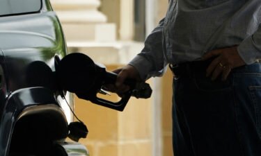 Gas prices hit yet another record high. A customer pumps gas into his vehicle