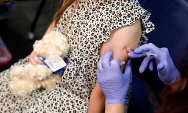 A 6 year-old child receives their first dose of  the Pfizer Covid-19 vaccine at the Beaumont Health offices in Southfield
