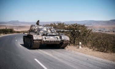 A damaged tank stands on a road north of Mekele